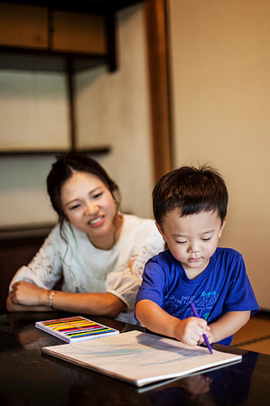 simsearch:6118-09079313,k - Smiling Japanese woman and little boy sitting at a table, drawing on white paper with colouring pens. Stock Photo - Premium Royalty-Free, Code: 6118-09200351