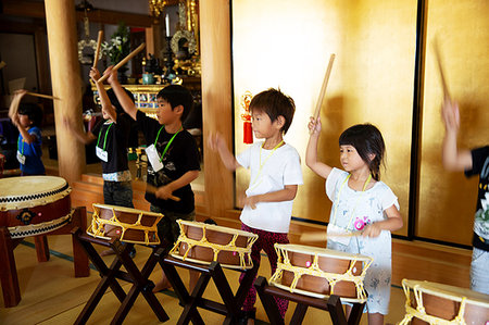 simsearch:855-03254989,k - Group of pre-school children playing the drums in a Japanese temple, a traditional religious practise. Stock Photo - Premium Royalty-Free, Code: 6118-09200542