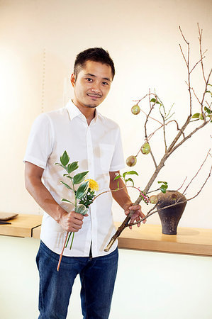 simsearch:6118-09079618,k - Japanese man working in a flower gallery, working on Ikebana arrangement. Stock Photo - Premium Royalty-Free, Code: 6118-09200568