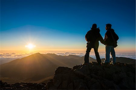 Tourists in backlight waiting for sunset. Haleakala National Park, Maui, Hawaii, United States of America, Pacific Stock Photo - Premium Royalty-Free, Code: 6119-07443890