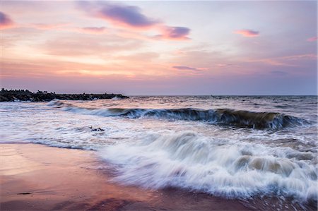 Waves crashing on Negombo Beach at sunset, West Coast of Sri Lanka, Asia Stock Photo - Premium Royalty-Free, Code: 6119-07451174