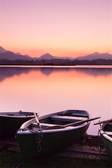 Rowing boats on Hopfensee Lake at sunset, near Fussen, Allgau, Allgau Alps, Bavaria, Germany, Europe Stock Photo - Premium Royalty-Free, Image code: 6119-07587391