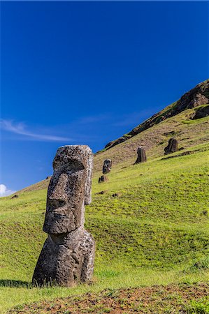Moai sculptures in various stages of completion at Rano Raraku, the quarry site for all moai on Easter Island, Rapa Nui National Park, UNESCO World Heritage Site, Easter Island (Isla de Pascua), Chile, South America Stock Photo - Premium Royalty-Free, Code: 6119-07734947