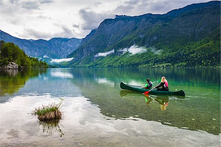 Mother and son canoeing on Lake Bohinj, Triglav National Park, Julian Alps, Slovenia, Europe Stock Photo - Premium Royalty-Free, Code: 6119-07845422