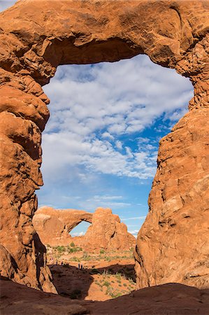 simsearch:6119-07943998,k - South Window Arch seen through Turret Arch, Arches National Park, Utah, United States of America, North America Stock Photo - Premium Royalty-Free, Code: 6119-07943960
