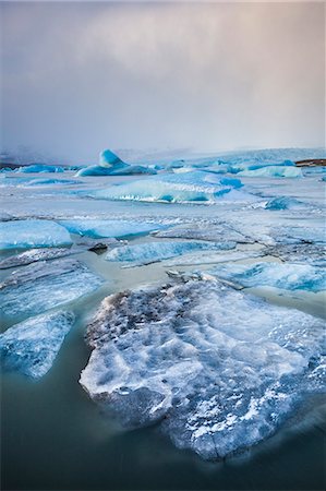sublimation - Frozen icebergs locked in the frozen waters of Fjallsarlon Glacier lagoon, South East Iceland, Iceland, Polar Regions Stock Photo - Premium Royalty-Free, Code: 6119-08081132