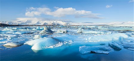 Panorama of mountains and icebergs locked in the frozen water, Jokulsarlon Iceberg Lagoon, Jokulsarlon, South East Iceland, Iceland, Polar Regions Stock Photo - Premium Royalty-Free, Code: 6119-08081135
