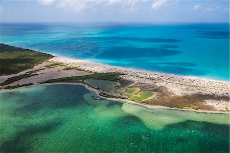 Aerial view of a corner of Barbuda, the Frigate Bird Sanctuary touches a thin strip of sand that separates the Caribbean Sea, Barbuda, Antigua and Barbuda, Leeward Islands, West Indies, Caribbean, Central America Photographie de stock - Premium Libres de Droits, Code: 6119-08126492