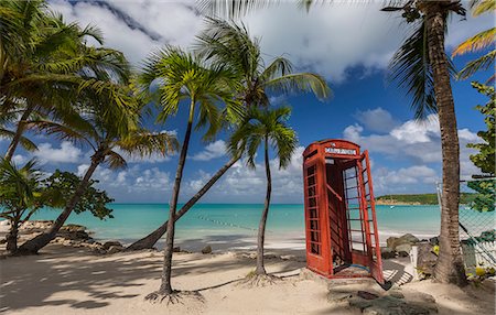 red call box - A red telephone box lies abandoned under coconut trees that surround Dickenson Bay, a strip of sand overlooking the Caribbean Sea, Antigua, Leeward Islands, West Indies, Caribbean, Central America Stock Photo - Premium Royalty-Free, Code: 6119-08126494