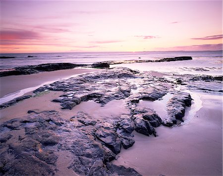 stones sand horizon - Sunrise over North Sea from Bamburgh beach, Bamburgh, Northumberland, England, United Kingdom, Europe Stock Photo - Premium Royalty-Free, Code: 6119-08266395