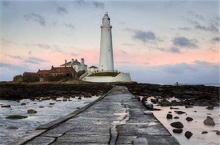 View along the tidal causeway to St. Mary's Island and St. Mary's Lighthouse at dusk, near Whitley Bay, Tyne and Wear, England, United Kingdom, Europe Stock Photo - Premium Royalty-Free, Code: 6119-08266437
