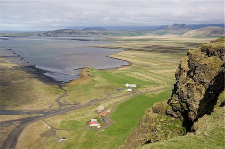 dyrholaey - View down to the coast at Dyrholaey showing isolated farms and distant mountains, near Vik i Myrdal, South Iceland, Iceland, Polar Regions Stock Photo - Premium Royalty-Free, Code: 6119-08266527