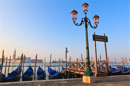 docked gondola buildings - Gondolas moored by Riva degli Schiavoni, looking towards San Giorgio Maggiore, Venice, UNESCO World Heritage Site, Veneto, Italy, Europe Stock Photo - Premium Royalty-Free, Code: 6119-08269500