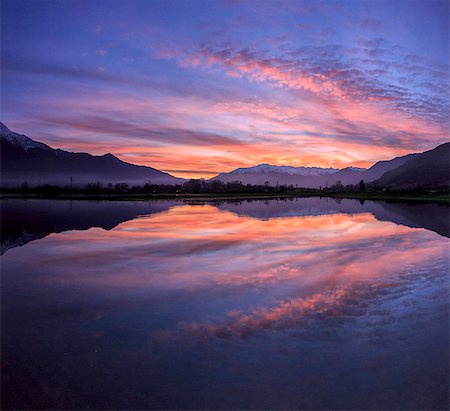 Panoramic view of Pian di Spagna flooded with snowy peaks reflected in the water at sunset, Valtellina, Lombardy, Italy, Europe Stock Photo - Premium Royalty-Free, Code: 6119-08420408