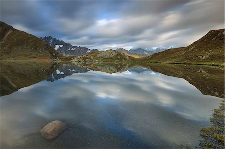 simsearch:6119-09238928,k - The snowy peaks are reflected in Fenetre Lakes at dawn, Ferret Valley, Saint Rhemy, Grand St Bernard, Aosta Valley, Italy, Europe Stock Photo - Premium Royalty-Free, Code: 6119-08541934
