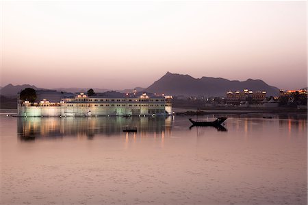 Perfect reflection of Lake Palace Hotel at dusk, situated in the middle of Lake Pichola, in Udaipur, Rajasthan, India, Asia Stock Photo - Premium Royalty-Free, Code: 6119-08568430
