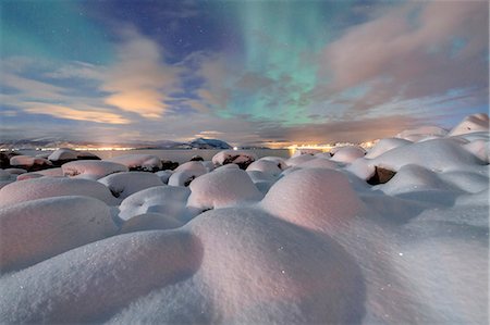 The pink light and the aurora borealis (Northern Lights) illuminate the snowy landscape on a starry night Stronstad, Lofoten Islands, Arctic, Norway Scandinavia, Europe Stock Photo - Premium Royalty-Free, Code: 6119-08641099