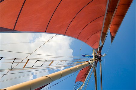 simsearch:6119-08740148,k - Red sails on sailboat that takes tourists out for sunset cruise, Key West, Florida, United States of America, North America Stock Photo - Premium Royalty-Free, Code: 6119-08740149