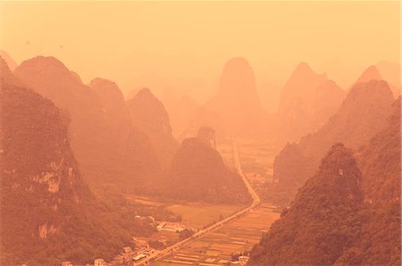 Karst landscape and morning haze, Yangshuo, Guangxi Province, China, Asia Stock Photo - Premium Royalty-Free, Code: 6119-08740836
