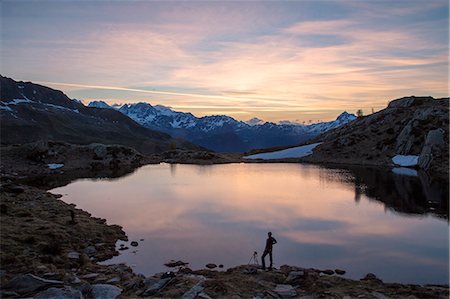 province of sondrio - Photographer admires the pink sunrise on Lake Zana, Malenco Valley, Valtellina, Province of Sondrio, Lombardy, Italy, Europe Photographie de stock - Premium Libres de Droits, Code: 6119-08797215
