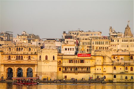 Old building facades, boat in foreground, City Palace side, Lake Pichola, Udaipur, Rajasthan, India, Asia Stock Photo - Premium Royalty-Free, Code: 6119-08725045