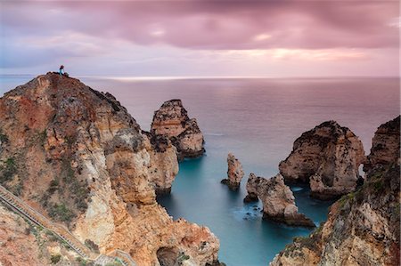 simsearch:6119-09161686,k - Photographer on top of cliffs surrounded by sea under the pink sky at sunrise, Ponta Da Piedade, Lagos, Algarve, Portugal, Europe Photographie de stock - Premium Libres de Droits, Code: 6119-09074039