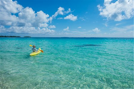 sea kayak - Woman kayaking in the turquoise waters of Tikehau, Tuamotus, French Polynesia, Pacific Stock Photo - Premium Royalty-Free, Code: 6119-09074243