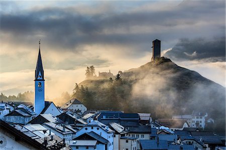 Misty sky on the alpine village of Ardez at sunrise, district of Inn, Lower Engadine, Canton of Graubunden, Switzerland, Europe Stock Photo - Premium Royalty-Free, Code: 6119-09074206