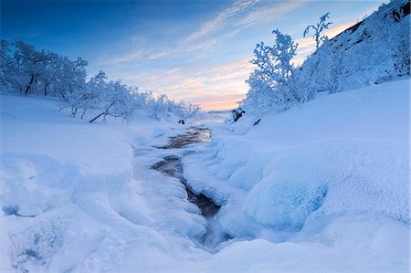 Sunrise on the frozen river and forest, Abisko, Kiruna Municipality, Norrbotten County, Lapland, Sweden, Scandinavia, Europe Stock Photo - Premium Royalty-Free, Code: 6119-09074217