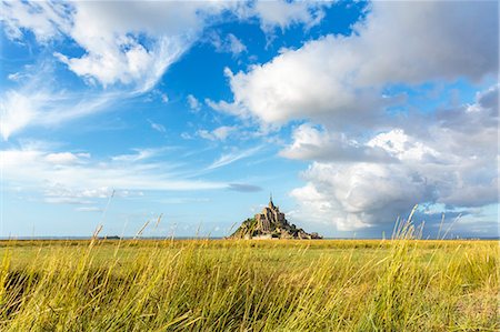 Clouds in the sky and grass in the foreground, Mont-Saint-Michel, UNESCO World Heritage Site, Normandy, France, Europe Stock Photo - Premium Royalty-Free, Code: 6119-09074597