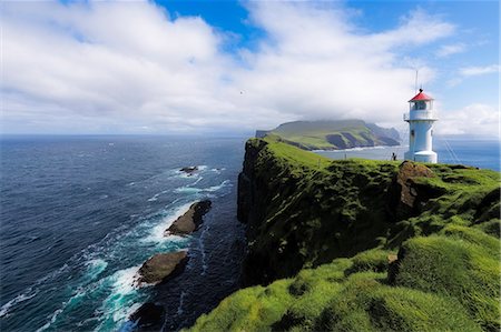 Lighthouse on islet known as Mykines Holmur, Mykines Island, Faroe Islands, Denmark, Europe Stock Photo - Premium Royalty-Free, Code: 6119-09161681