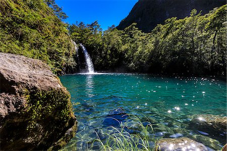 Waterfall, lake and blue sky, Petrohue Los Enamorados Trail, Vicente Perez Rosales National Park, Spring, Lakes District, Chile, South America Stock Photo - Premium Royalty-Free, Code: 6119-09170035