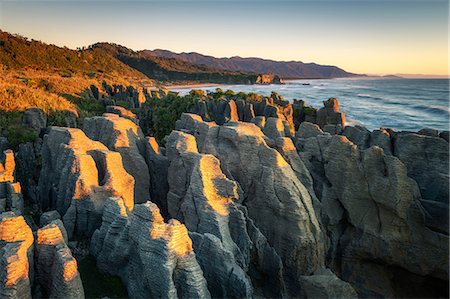 extreme terrain - Pancake Rocks at sunset, Paparoa National Park, West Coast, South Island, New Zealand, Pacific Stock Photo - Premium Royalty-Free, Code: 6119-09170147