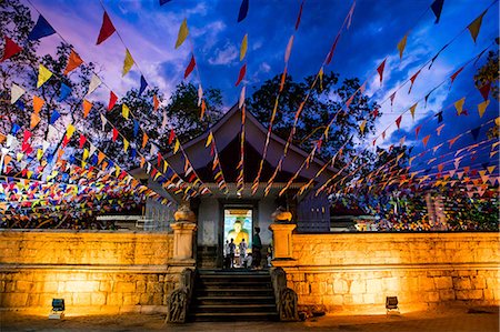 full body praying - Making a prayer offering with lotus flowers at a Buddhist temple in Sri Lanka, Asia Stock Photo - Premium Royalty-Free, Code: 6119-09170152