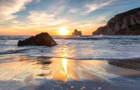 The sunset reflected on the Beach of Masua, Iglesias, Sud Sardegna province, Sardinia, Italy, Mediterranean, Europe Stock Photo - Premium Royalty-Free, Code: 6119-09253315