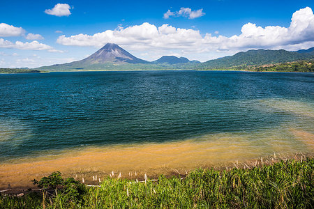 Arenal Volcano behind Laguna de Arenal (Arenal Lake), Alajuela Province, Costa Rica, Central America Stock Photo - Premium Royalty-Free, Code: 6119-09202872