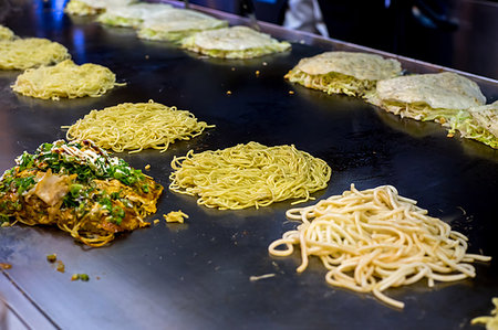 Okonomiyaki being prepared on a large griddle, Hiroshima, Japan, Asia Stock Photo - Premium Royalty-Free, Code: 6119-09203667