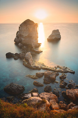 province of lecce - Sunrise at the Faraglioni of Torre dell'Orso, Meledugno, Lecce province, Apulia, Italy, Europe Stock Photo - Premium Royalty-Free, Code: 6119-09214263