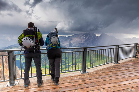 passo pordoi - Two mountain climbers watch the storm above Marmolada, Pordoi Pass, Fassa Valley, Trentino, Dolomites, Italy, Europe Stock Photo - Premium Royalty-Free, Code: 6119-09228740