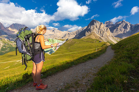 people on trail with map - Hiker reading map near San Nicolo Pass, Fassa Valley, Trentino, Dolomites, Italy, Europe Stock Photo - Premium Royalty-Free, Code: 6119-09228784