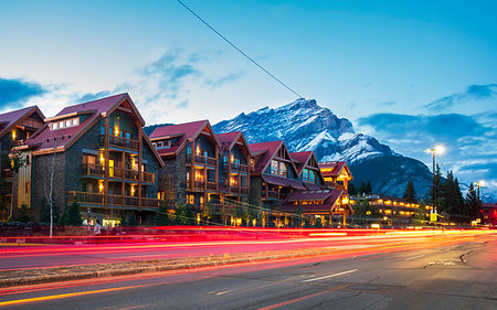 simsearch:6119-09228810,k - Trail lights on Banff Avenue and mountains in background at dusk, Banff, Banff National Park, Alberta, Canada, North America Stock Photo - Premium Royalty-Free, Code: 6119-09228811