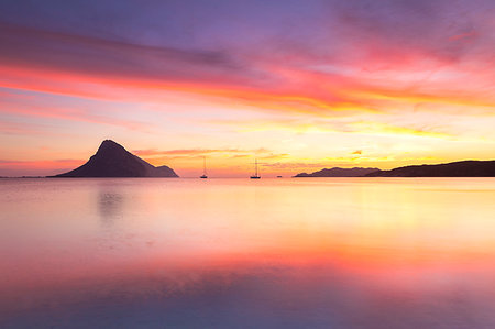 sonrisa sardónica - Amazing sunrise on the beach of Porto Taverna with the Tavolara Island in the background, Loiri Porto San Paolo, Olbia Tempio province, Sardinia, Italy, Mediterranean, Europe Stock Photo - Premium Royalty-Free, Code: 6119-09238892