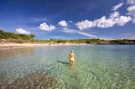 simsearch:6119-09238915,k - A girl in swimsuit walks in the water, La Bobba Beach, San Pietro Island, Sud Sardegna province, Sardinia, Italy, Mediterranean, Europe Photographie de stock - Premium Libres de Droits, Code: 6119-09238913