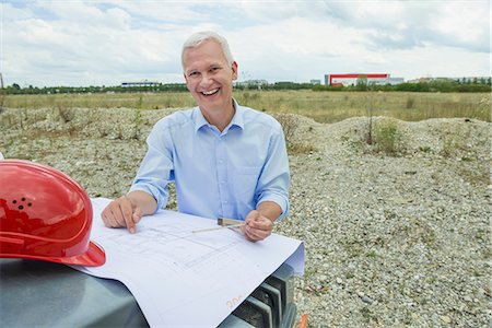 Architect checking construction plan Stock Photo - Premium Royalty-Free, Code: 6121-07740327