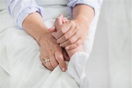 Woman holding patient's hand Stock Photo - Premium Royalty-Free, Code: 6121-07740453