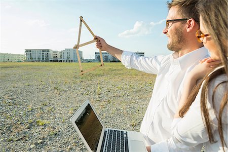 real estate - Happy couple with laptop at development area Stock Photo - Premium Royalty-Free, Code: 6121-07740778