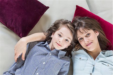 elementary age - Portrait of mother and daughter lying on floor, smiling Stock Photo - Premium Royalty-Free, Code: 6121-07740976