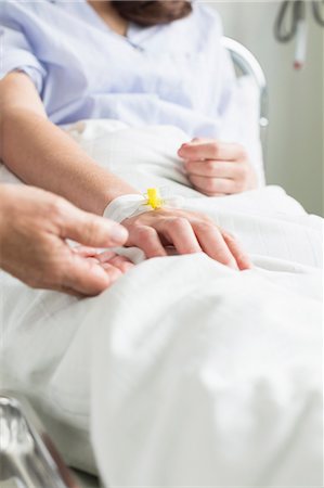 Doctor preparing infusion needle Stock Photo - Premium Royalty-Free, Code: 6121-07741170
