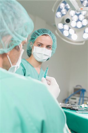 Surgeons performing operation Stock Photo - Premium Royalty-Free, Code: 6121-07741199