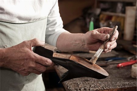 Cobbler working in workshop, close-up Stock Photo - Premium Royalty-Free, Code: 6121-07741889